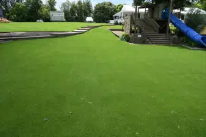heat‑reduction artificial grass installed in a sunny school courtyard